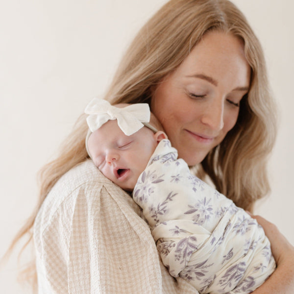 Newborn girl wrapped in an ultra-cozy and soft baby swaddle, offering a luxurious embrace for your newborn.