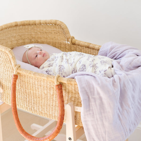 Light purple floral, luxuriously soft baby swaddle, perfect for wrapping your little one in cozy comfort.