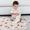 Little child reading a book on a beautiful highland cow bamboo muslin swaddle. 