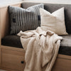 Tan soft Boucle blanket draped over a couch, ideal for snuggling up - Saranoni