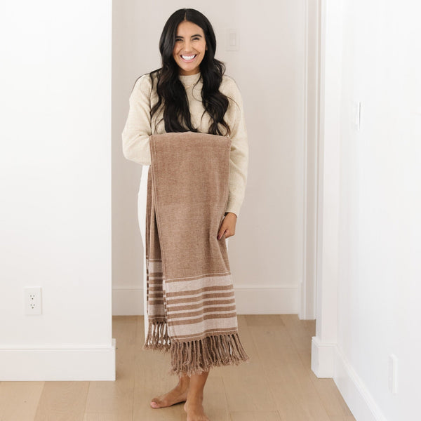 Saranoni luxurious chenille fringe throw blanket in her cozy home