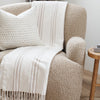 Comfy chenille fringe blanket draped over a contemporary chair - Saranoni