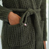 Detail of a waffle knit robe's pocket, showcasing the intricate knit pattern.