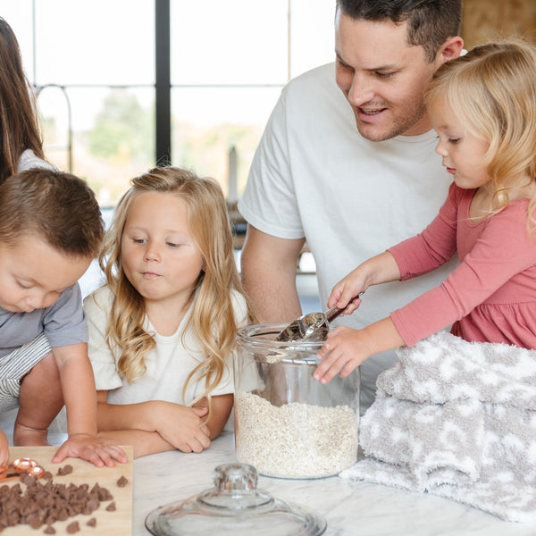 Loving family making cookies in the kitchen with Gray Leopard DOUBLE-LAYER BAMBONI MINI BLANKETS - Saranoni