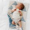 Newborn baby boy laying on blue Triangle DOUBLE-LAYER BAMBONI MINI BLANKETS - Saranoni