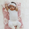 Baby girl laying on beautiful pink Petal DOUBLE-LAYER BAMBONI MINI BLANKETS - Saranoni