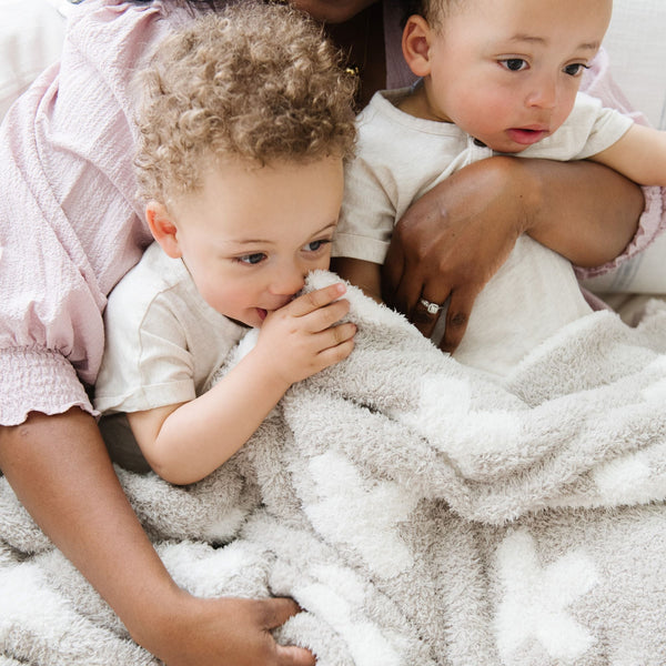 Mom wrapping two little boys in Swiss Cross DOUBLE-LAYER BAMBONI MINI BLANKETS - Saranoni