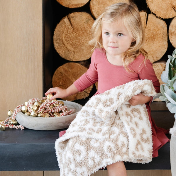 Little girl holding on to beautiful, soft and stretchy, Tan Leopard DOUBLE-LAYER BAMBONI MINI BLANKETS - Saranoni