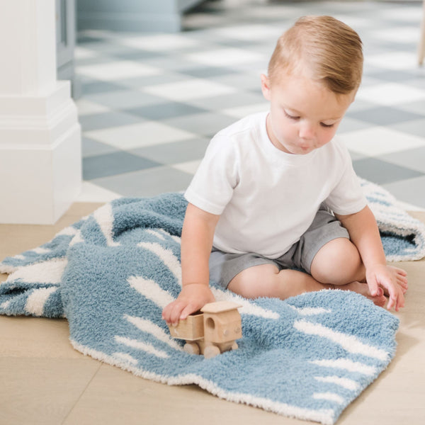 Adorable little boy playing with wooden cars on blue Triangle DOUBLE-LAYER BAMBONI MINI BLANKETS - Saranoni