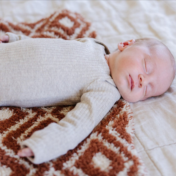 Newborn baby boy peacefully sleeping on top of super soft Khmer DOUBLE-LAYER BAMBONI MINI BLANKETS - Saranoni