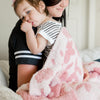 Mom and little girl snuggling in super soft Pink Pansy DOUBLE-LAYER BAMBONI RECEIVING BLANKETS - Saranoni