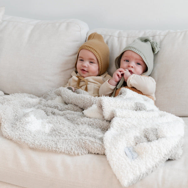 Two little boys sitting with beautiful Swiss Cross DOUBLE-LAYER BAMBONI RECEIVING BLANKETS - Saranoni