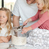 Family making cookies in the kitchen, with little kids playing on adorable Gray Leopard DOUBLE-LAYER BAMBONI RECEIVING BLANKETS - Saranoni