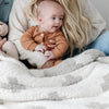 Mom and baby snuggling together in beautiful Swiss Cross DOUBLE-LAYER BAMBONI RECEIVING BLANKETS - Saranoni