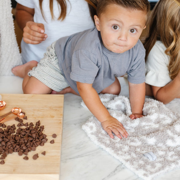 Little boy playing in the kitchen with extra soft Gray Leopard DOUBLE-LAYER BAMBONI RECEIVING BLANKETS - Saranoni