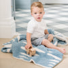 Little boy playing with wooden cars, sitting on soft and comfy Blue Triangle DOUBLE-LAYER BAMBONI RECEIVING BLANKETS - Saranoni