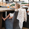 Little girl sitting up to breakfast table with beautiful, soft and cozy Tan Leopard DOUBLE-LAYER BAMBONI RECEIVING BLANKETS - Saranoni