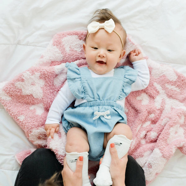 Adorable little baby and mom playing on beautiful Pink petal DOUBLE-LAYER BAMBONI RECEIVING BLANKETS - Saranoni