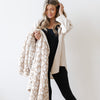 Woman holding extra stretchy soft and thick Tan Leopard DOUBLE-LAYER BAMBONI THROW BLANKETS - Saranoni