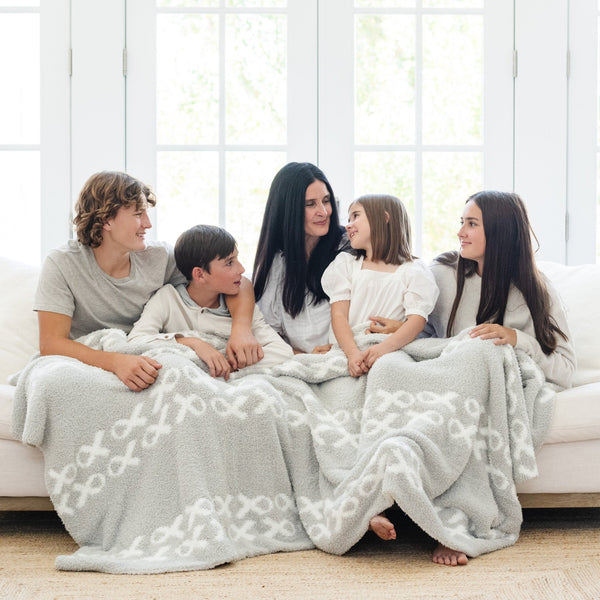 Peterson Family snuggled together in beautiful Gray and White HOPE DOUBLE-LAYER BAMBONI® THROW BLANKETS - Saranoni