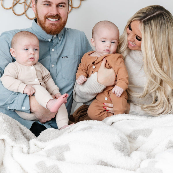 Beautiful family snuggling together in special Gray and White HOPE DOUBLE-LAYER BAMBONI THROW BLANKETS - Saranoni