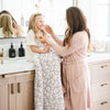 Mom and daughter in a beautifully decorated bathroom, sitting with extra soft and stretchy Gray Leopard DOUBLE-LAYER BAMBONI TODDLER BLANKETS - Saranoni