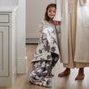 Little girl holding on to super soft and heavy Purple Pansy DOUBLE-LAYER BAMBONI TODDLER BLANKETS - Saranoni