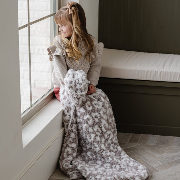 Little girl sitting in the window sill with a beautiful Gray Leopard DOUBLE-LAYER BAMBONI® TODDLER BLANKETS - Saranoni