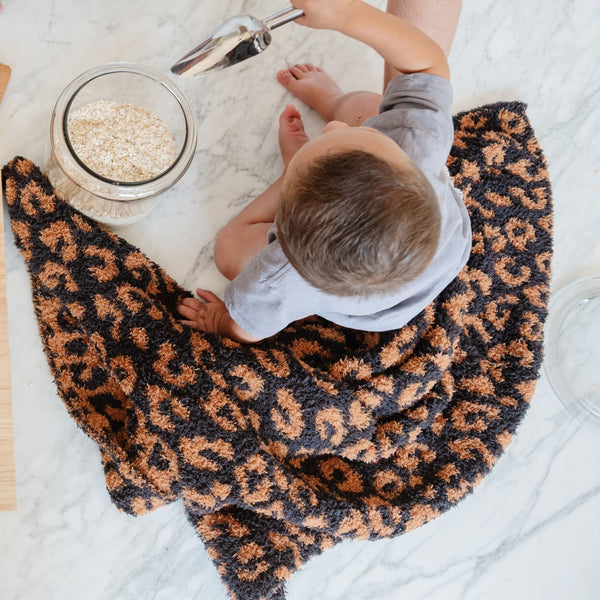 Young boy helping to make cookies in the kitchen, sitting with beautiful Classic Leopard DOUBLE-LAYER BAMBONI TODDLER BLANKETS - Saranoni