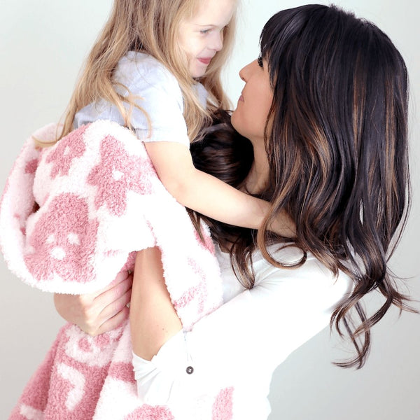 Mom and daughter smiling together, wrapped in Pink Petal DOUBLE-LAYER BAMBONI TODDLER BLANKETS - Saranoni