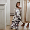 Mom and little girl in the kitchen, holding on to Purple Pansy DOUBLE-LAYER BAMBONI TODDLER BLANKETS - Saranoni