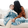 Mom kissing little kid's forehead, wrapped in beautiful and soft Blue + White Stripe Triangle DOUBLE-LAYER BAMBONI TODDLER BLANKETS - Saranoni