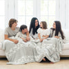 Peterson family snuggled up together in gray and white HOPE DOUBLE-LAYER BAMBONI® XL BLANKETS - Saranoni