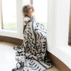 Little girl snuggled up with beautiful, soft and cozy Mudcloth DOUBLE-LAYER BAMBONI XL BLANKETS - Saranoni