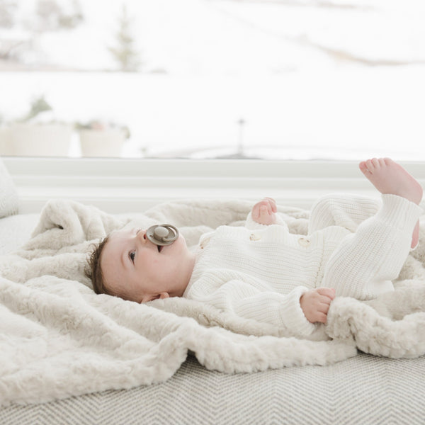 Baby laying on neutral color DREAM RECEIVING BLANKETS - Saranoni