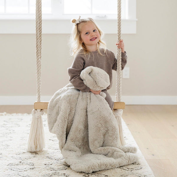 Girl on swing with DREAM RECEIVING BLANKETS - Saranoni