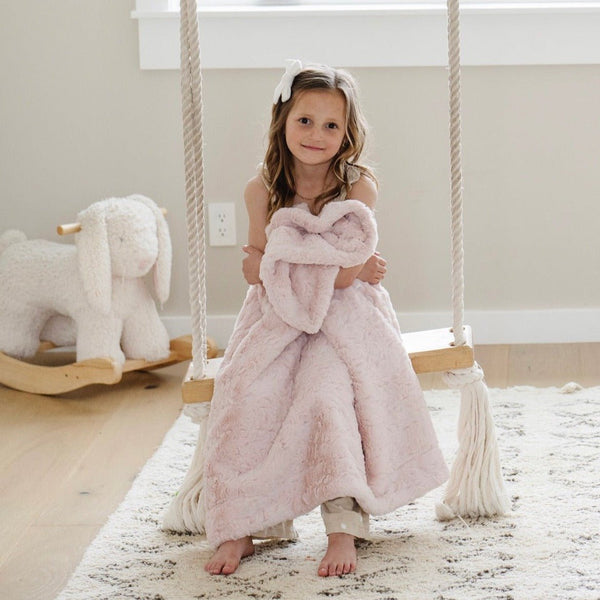 Toddler on swing with blush pink DREAM RECEIVING BLANKETS - Saranoni