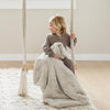 Toddler playing with soft and cozy DREAM RECEIVING BLANKETS - Saranoni