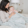 Baby and mom snuggling with Heather blue DREAM RECEIVING BLANKETS - Saranoni