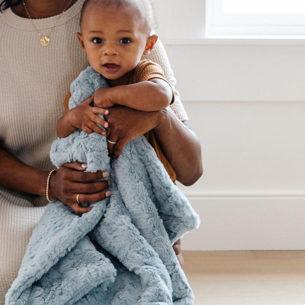 Mom and baby playing with heather blue DREAM RECEIVING BLANKETS - Saranoni