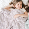 young girl snuggling with DREAM TODDLER BLANKETS - Saranoni