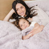 Mom and daughter laying in bed with DREAM TODDLER BLANKETS - Saranoni