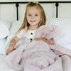 Young girl holding soft and cozy DREAM TODDLER BLANKETS - Saranoni