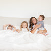 FAUX FUR FULL/QUEEN BLANKETS - Luxuriously soft Saranoni blanket spread across a full-sized bed with generous overhang.