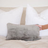 Saranoni Grand knit pillow cover on a cozy bed with blankets