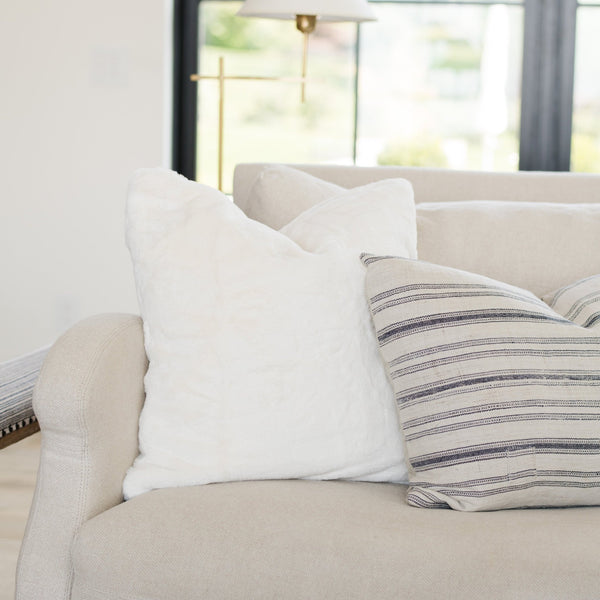 Fluffy Saranoni Grand Pillow Cover on a Chair - Perfect accent piece for any sitting area, offering unmatched comfort.