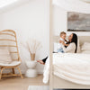 Mom and kid relaxing with a super soft Saranoni blanket in a bedroom.