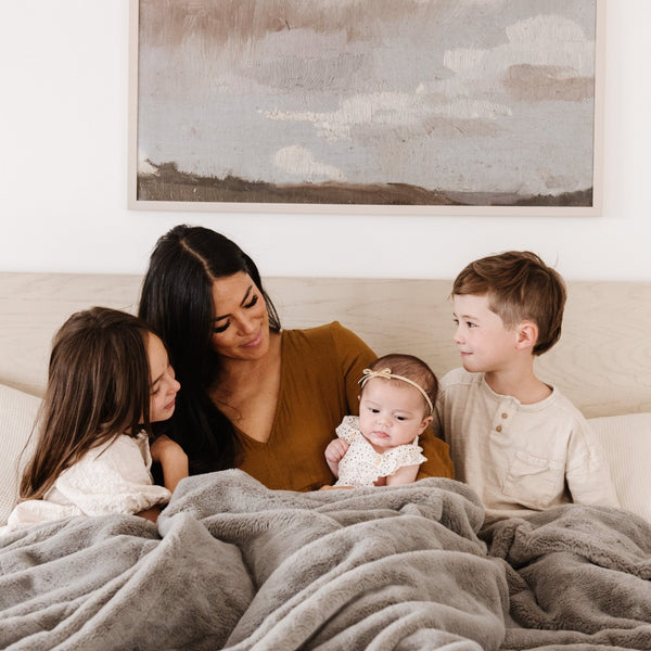 Large Saranoni blanket draped over a king-sized bed with a 16-inch drop.