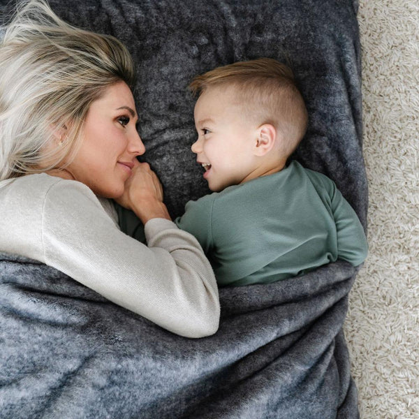 GRAND FAUX FUR SLEEPING BAGS - Little boy and his mom cuddling in a medium gray mink sleeping bag, feeling the softness.