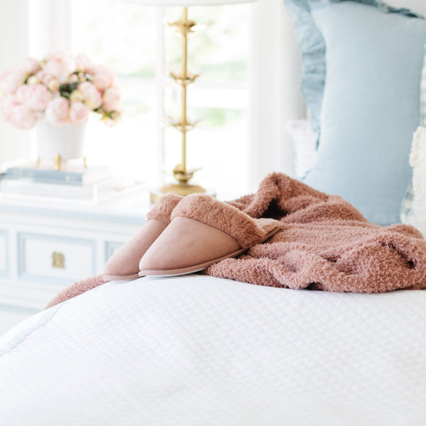 Bedroom with Saranoni faux fur slippers and best blankets and throws